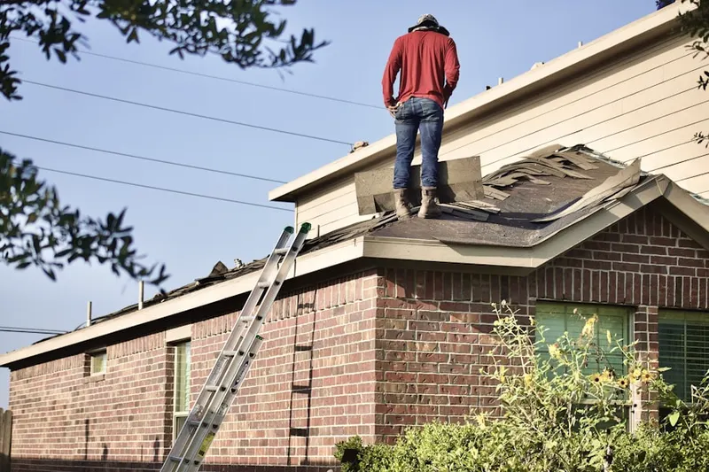 Professional roofer working on a residential roof in Foustwell